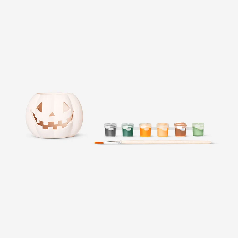 DIY pumpkin tealight holder with paint and brush